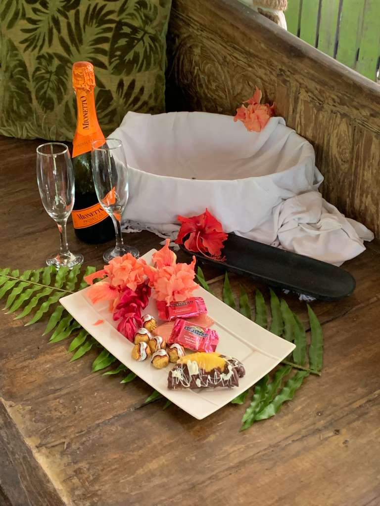 Sparkling wine, fresh fruit and chocolates set up for a celebration at the spa
